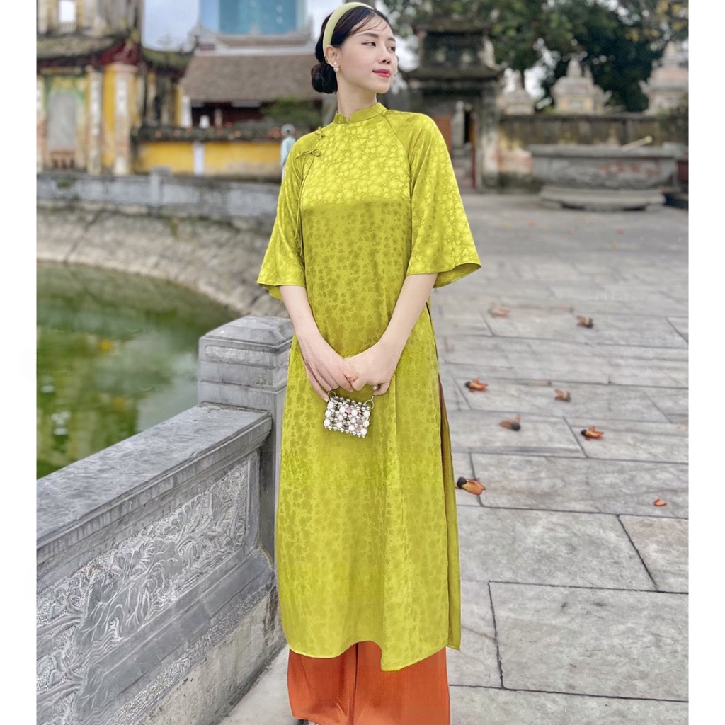 Áo dài dáng suông đính nơ gấm hoa xing xắn