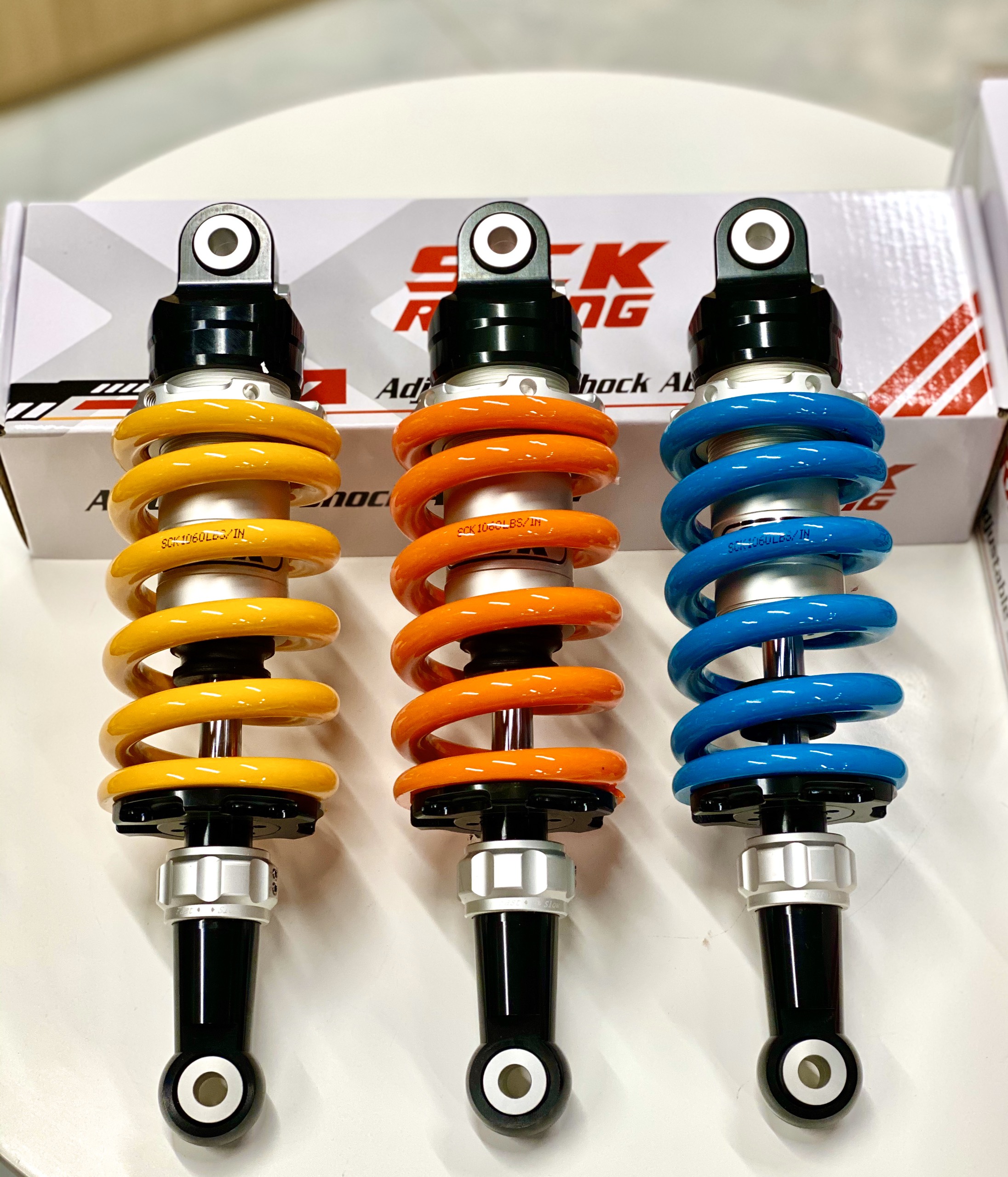 PHUỘC SAU CHO RAIDER/SATRIA 150 (SCK-01-285MM) 1 TĂNG CHỈNH KHÔNG BÌNH DẦU (MÀU XANH + CAM+ VÀNG)