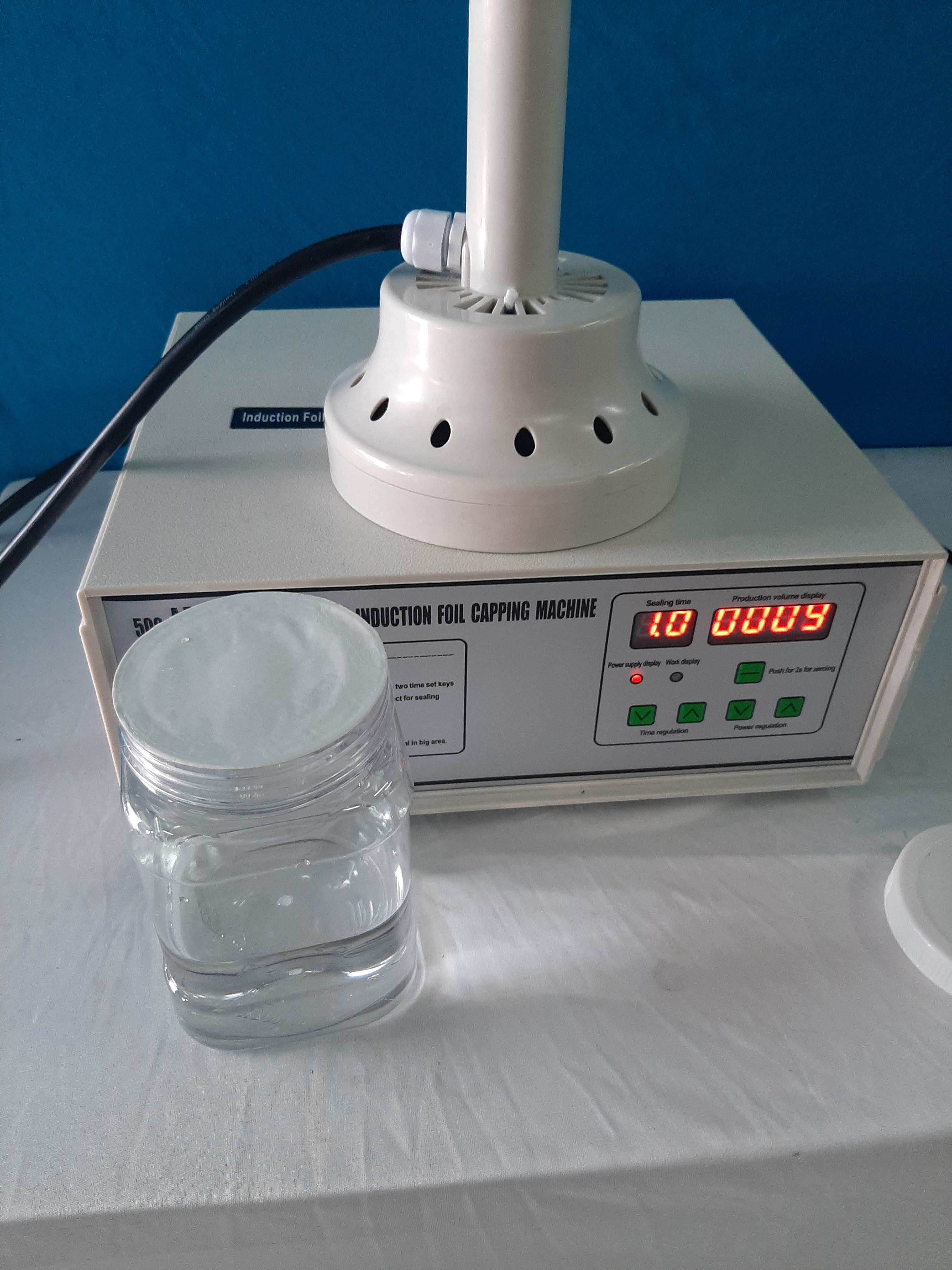 Máy dán màng seal, dán màng nhôm miệng chai hũ nhựa 500C đầu lớn 130mm