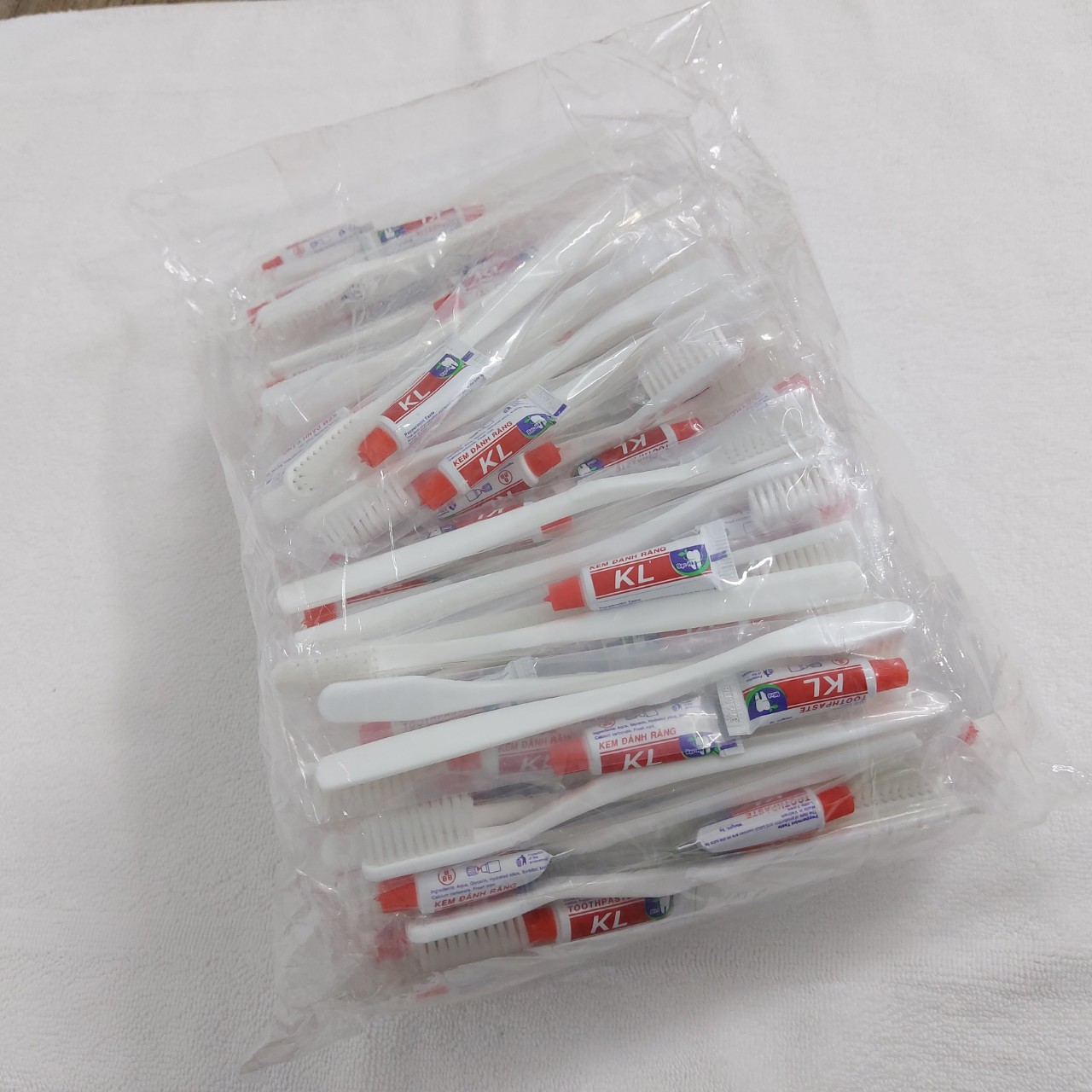 Bàn Chải Đánh Răng Trắng 42 RIOTEX - Bịch 100 Chiếc Kèm Kem Đánh Răng Kem Đỏ Cho Khách Sạn Nhà Nghỉ