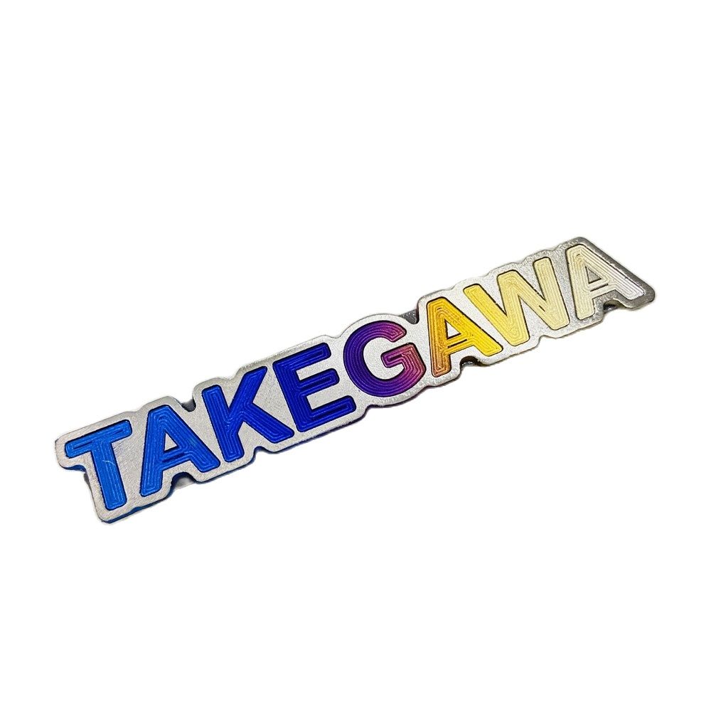 Tem logo takegawa dài chất liệu titan gr5 dán trang trí gắp dàn áo xe máy
